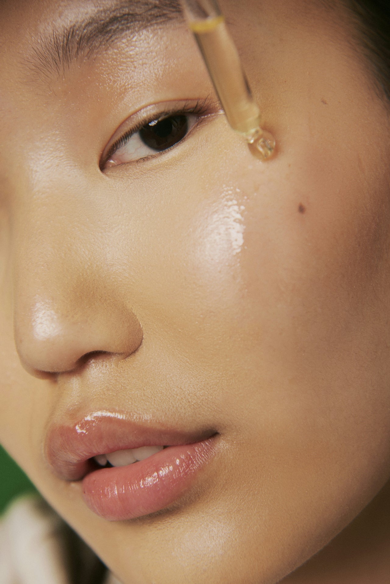 Close-up of a person applying dropper of liquid to their eye