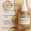 Frondescent skincare oil bottle with product features on a beige background