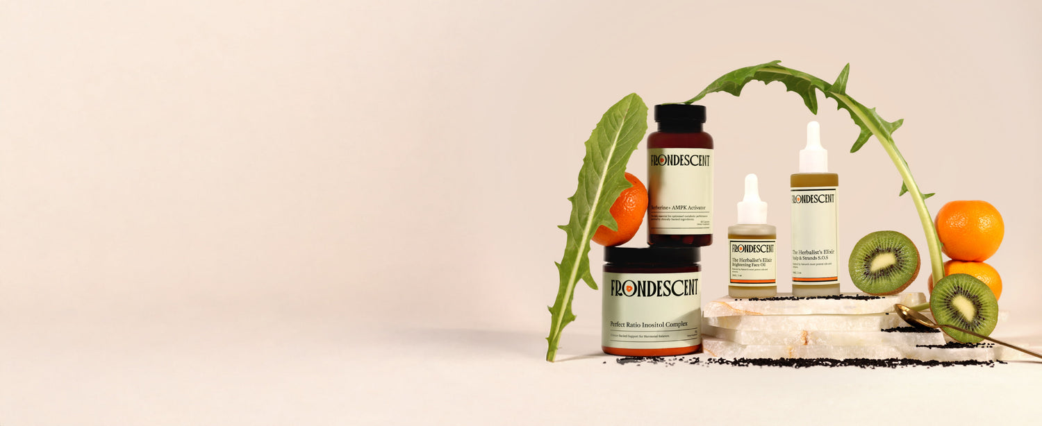 Frondescent skincare, haircare, and supplement products with fruits and a plant on a beige background
