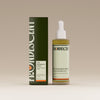 Bottle and box of Herbalist's Elixir Hair oil on a beige background