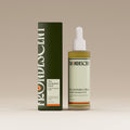 Bottle and box of Herbalist's Elixir Hair oil on a beige background