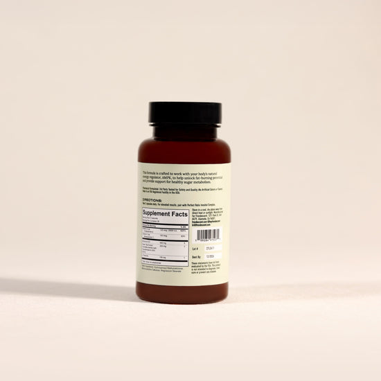 Back of Frondescent Berberine+AMPK Activator bottle on a beige background. Helps regulate hormones, blood sugar, and help with insulin resistance.