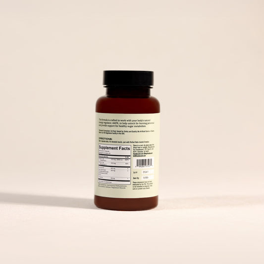 Back of Frondescent Berberine+AMPK Activator bottle on a beige background. Helps regulate hormones, blood sugar, and help with insulin resistance.