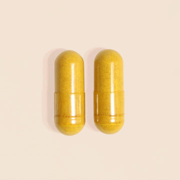Frondescent Berberine+AMPK Activator capsules on a beige background. Helps regulate hormones, blood sugar, and help with insulin resistance.