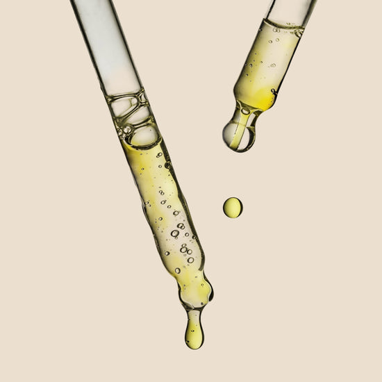 Close-up of a dropper with the Herbalist's Elixir Facial Oil dripping 