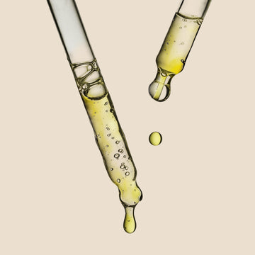 Close-up of a dropper with the Herbalist's Elixir Facial Oil dripping 