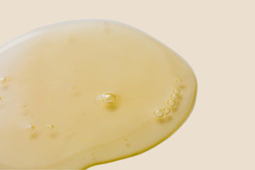 Close-up of an oil on a beige background